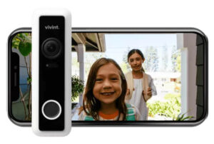 Vivint Doorbell Camera Pro in front of a cellphone showing a live view from the camera featuring a little girl and a woman.